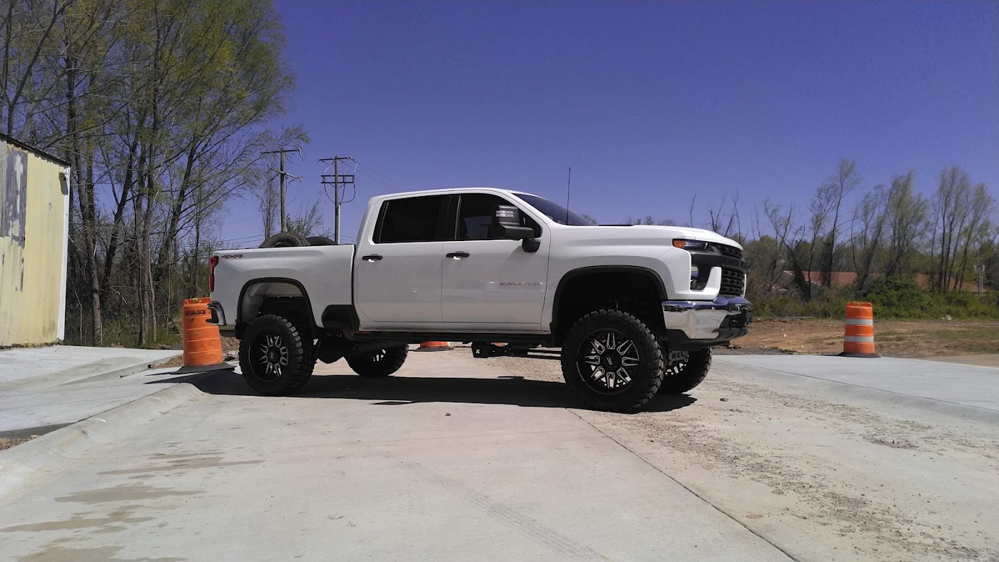 White lifted Chevrolet Silverado HD