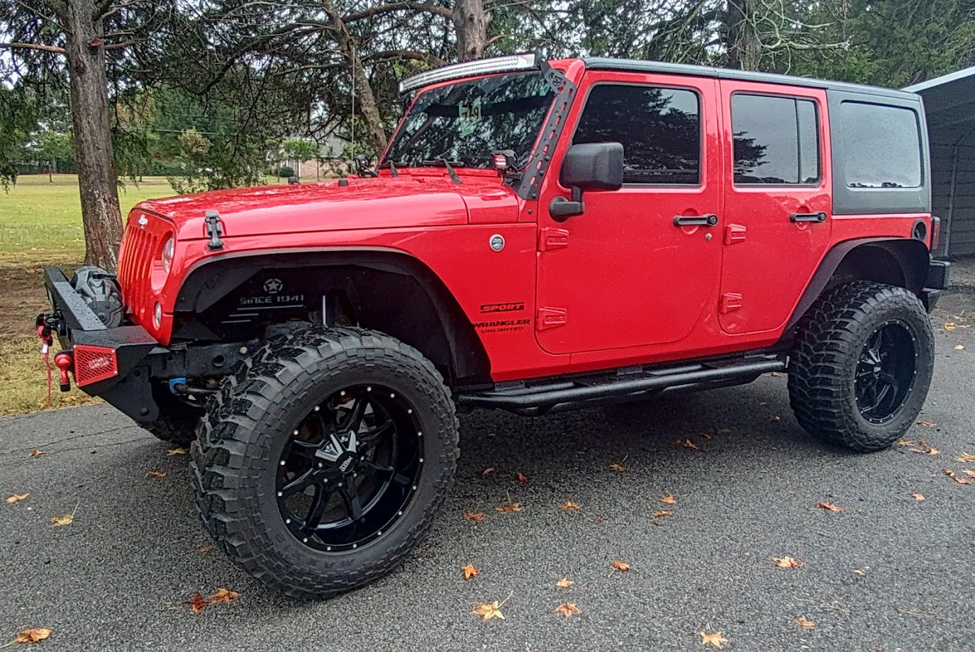 Finished red Jeep Wrangler parked outside