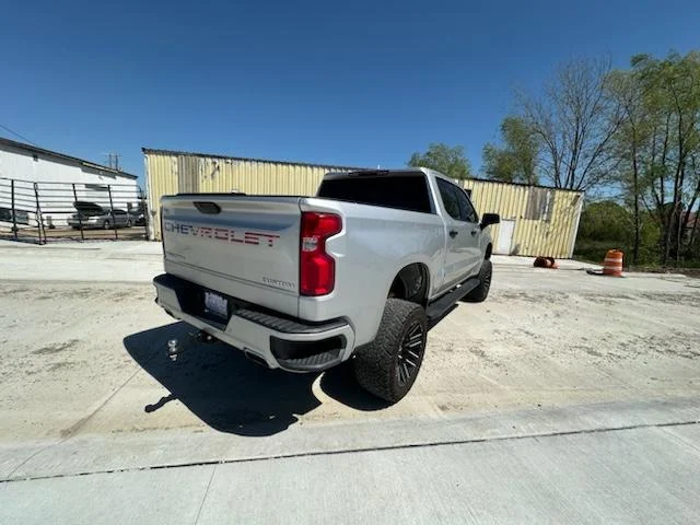 Silver Silverado parked outside the shop